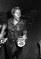 Waitress carrying a pitcher and ice bucket after clearing off a table at the Laicos Club in Montgomery, Alabama.