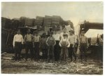 These were the youngest white boys (there were several younger negroes) that I could find working in the Parker Heading Co. Lumber Yards, Poplar Bluff, Mo. (Sometimes called the Great Western Lumber Co.) I went through the buildings and yards. Smallest white boy is Frank Childers, Front St., Poplar Bluff. He and the other small boys help trim and carry strips to make barrel headings. Location: Poplar Bluff, Missouri.