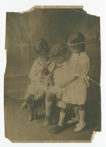 Photograph of Edward, Walter, and Kathleen Mitchell holding a kitten