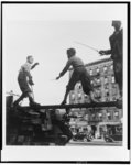 [Four boys, three of them on beam of ruins(?) of building, playing with toy swords, Harlem, New York]