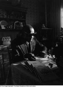 Photograph of Rev. James Garfield Owens and his book