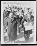 [Rev. Ralph Abernathy walking with Dr. Martin Luther King, Jr., as they lead civil rights marchers out of camp to resume their march to Montgomery, Alabama]