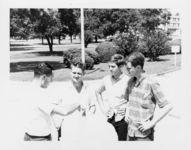 Mississippi State Sovereignty Commission photograph of Richard Barrett holding a proclamation while three teenagers look on during a demonstration on the grounds of the Mississippi State Capitol, Jackson, Mississippi, 1967 July 30