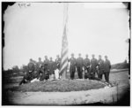 [Washington, D.C. Signal Corps officers lowering flag at their camp near Georgetown; Gen Albert J. Myer, in civilian dress, at right of pole]