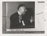 Mississippi State Sovereignty Commission photograph of a profile view of Daniel E. Byrd standing at a wooden podium with the palms of his hands extended, New Orleans, Louisiana, 1950s