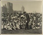 [Police officer in front of crowd of children and adults at Federal Theatre Project performance in Central Park, New York]