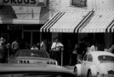 Protestors carrying signs while marching past The Hobby Shop in downtown Prattville, Alabama, during a civil rights demonstration.