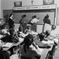 Children solving arithmetic problems on the blackboard in a classroom at Nazareth Catholic Mission in Montgomery, Alabama.