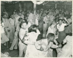 African American soldiers and their peer civilians dancing in the hall of a recreational facility