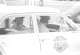 Eugene Harrison and another officer seated in a car during a student demonstration in Tuskegee, Alabama, to protest the murder of Samuel L. Younge, a civil rights worker.