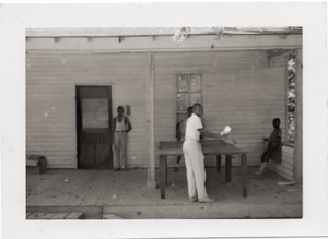 Unidentified children playing ping pong on porch of Rust Avenue house rented by the Congress of Federated Organizations (COFO)