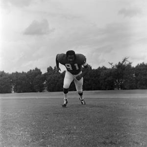 Football player running on the field, 75