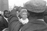 Female reporter listening to a man on Auburn Avenue on the day of Martin Luther King, Jr.'s funeral.