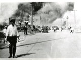 Smoke engulfs buildings and the sky on Archer Street