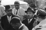 Journalist interviewing Martin Luther King Jr. as he and others march to the Dallas County courthouse in Selma, Alabama, during a civil rights demonstration.