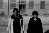 Sallie M. Hadnott, a local civil rights activist, and a young woman standing in front of a brick church building in Prattville, Alabama.