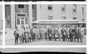 Men in front of Rialto tour bus and columned building : acetate film photonegative