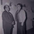 Film negatives of a man and woman standing in front of a western themed wall painting, May 5, 1955