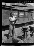 Baltimore, Maryland. A rivet heater preparing to toss a red hot rivet to be used in the building of the Liberty ship Frederick Douglass at the Bethlehem-Fairfield shipyards