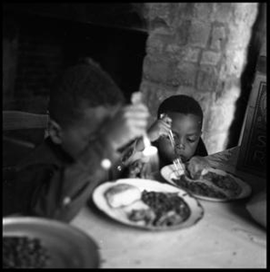 Two Children Eating at a Table