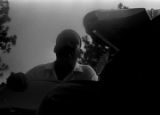 Whitney M. Young, Jr., speaking to Martin Luther King, Jr., while seated on a platform in front of the state capitol in Jackson, Mississippi, at the end of the "March Against Fear" begun by James Meredith.