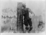 [Spectators looking at charred corpse of Jesse Washington hanging from tree after lynching, Waco, Texas, May 15, 1916]