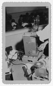 Photograph of a man operating a film projector for school children, Manchester, Georgia, 1953