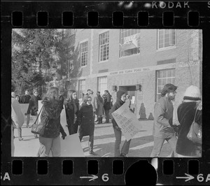 White students parade with placards outside Ford Hall at Brandeis University