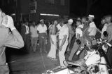 Young African American man confronting another man in front of J. D.'s Grocery after the bombing of the Gaston Motel in Birmingham, Alabama.