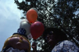 Man holding balloons during Bicentennial Celebration