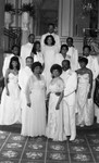 Cotillion attendees posing for a portrait on ballroom stairs, Los Angeles, 1986