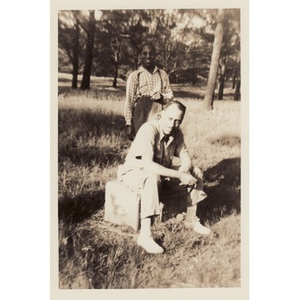 Reverend Dr. Wm. Frederick Fisher sits on a crate