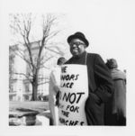 Mississippi State Sovereignty Commission photograph of an unidentified African American male wearing a protest sign around his neck during a demonstration, Atlanta, Georgia, 1960s