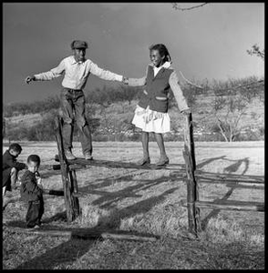 Bailey Woods and Sue Antoinette Emory Standing on Fence