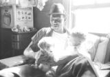 Percy Jones, Jr., holding a puppy and his daughter Barbara in his home on Clayton Alley in Montgomery, Alabama.