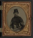 [Unidentified soldier in Union first sergeant's uniform with militia sword and revolver]