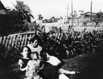 Woman and children in front yard