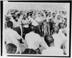 [Dr. Martin Luther King, Jr., hands outstretched, addressing group of African Americans in Albany, Ga.]