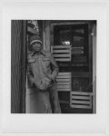 [Lower West Side, Buffalo, N.Y. Samuel P. "Pee Wee" West, African-American, three-quarter length portrait, facing front, standing, leaning against wall outside store]