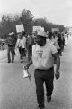 Marchers during the 20th anniversary reenactment of the Selma to Montgomery March, probably in rural Dallas or Lowndes County, Alabama.