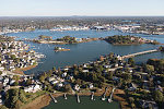 An October 2017 aerial view of the historic seaport of Portsmouth, New Hampshire, the largest city along the shortest coastline (18 miles) of any U.S. state. The focus is on small islands in the Piscataqua River, with the town of New Castle (also in New Hampshire) in the distance. Portsmouth also lies directly across another stretch of the river from Kittery, the southernmost point of the state of Maine