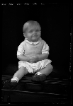 Portrait of infant sitting on table