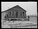 [Untitled photo, possibly related to: Building a porch for a house that had been carried out of the Santee-Cooper basin by a Negro family. Near Bonneau, South Carolina region]