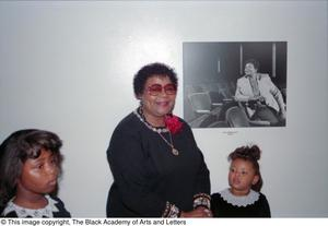 Dr. Versia Lacy posing with her portrait