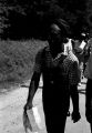 Edward Rudolph holding a sheet of paper while leading marchers down a street in Prattville, Alabama, during a demonstration sponsored by the Autauga County Improvement Association.