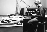 A student sits at the microphone in a recording booth for WMUR, 1973-1974