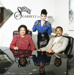 Shelly Garrett posing with others in his office, Los Angeles