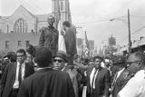 T. Y. Rogers and Jesse Jackson on the cart carrying Martin Luther King, Jr.'s casket during the funeral procession on Auburn Avenue.