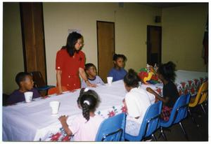 Children at Table and Links Member During Christmas Party