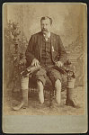 [John W. January, veteran of Co. B, 14th Illinois Cavalry Regiment, with prosthetic legs]